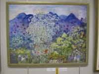 青い山々を背景に黄と白と紫と赤い花が生い茂っている絵画